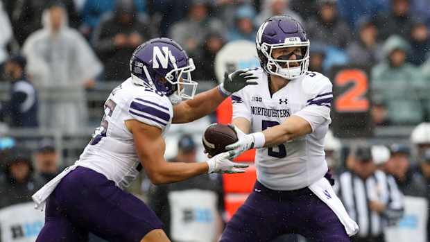 Northwestern Wildcats quarterback Ryan Hilinski (3) hands the ball off to running back Evan Hull (26) during the first quarter against the Penn State Nittany Lions at Beaver Stadium.